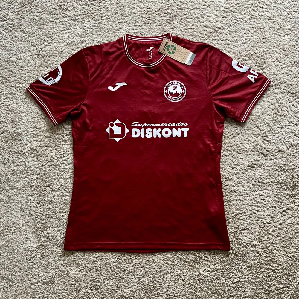 Front view of Ciutadella CE 2026/27 Joma Home Shirt (Supermercados Diskont) - Men's Large
